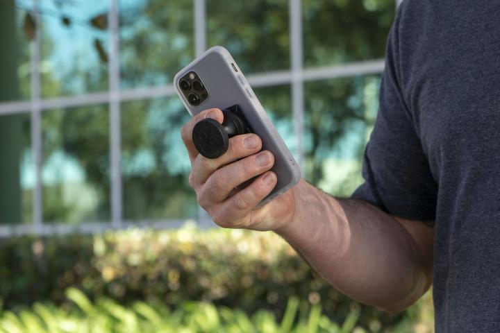 man holding phone with MobNetic GO attached